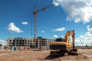 excavator-construction-site-against-background-tower-crae